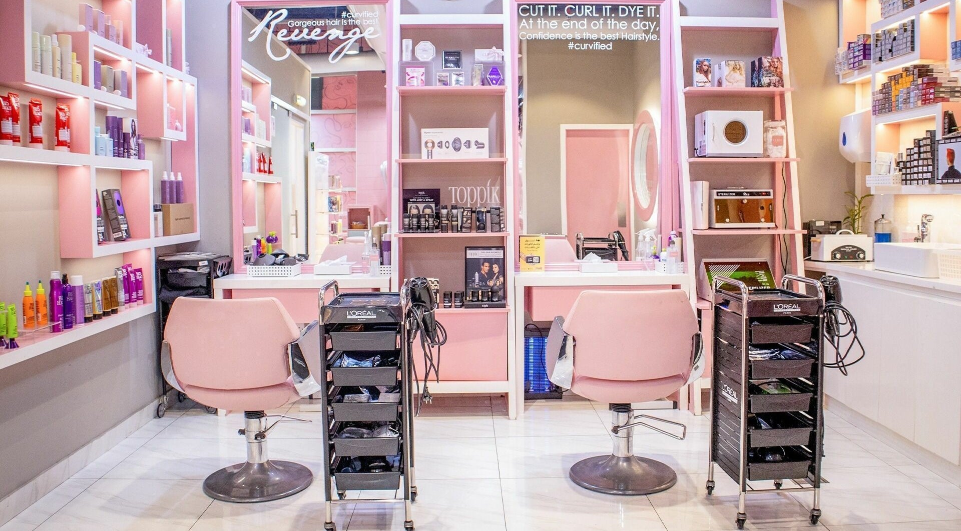 Curve Beauty Salon's stylish interior in Dubai, Dubai, AE, features elegant pink chairs and beauty products.