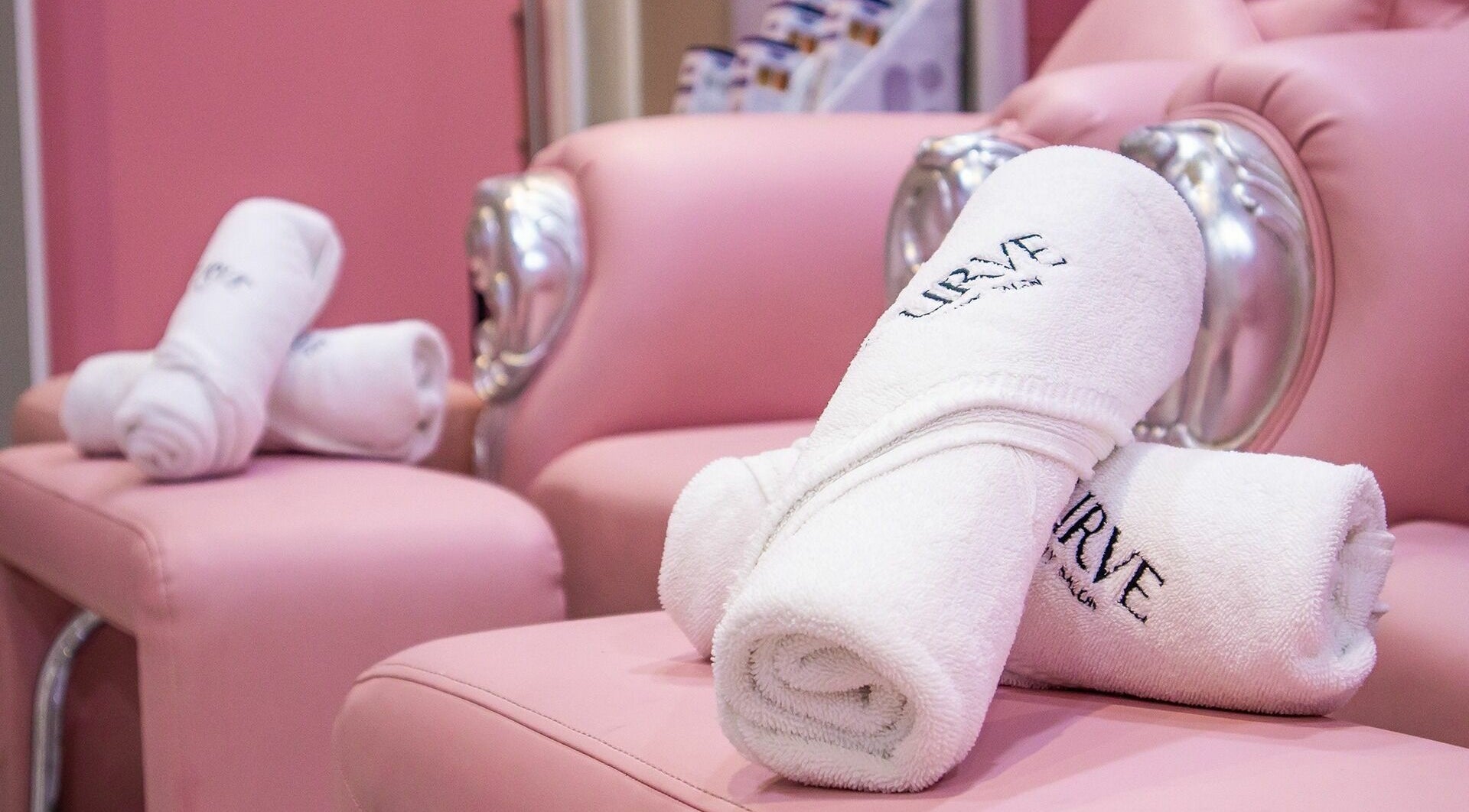 Luxurious pink seating with branded towels at Curve Beauty Salon, Dubai, Dubai, AE.