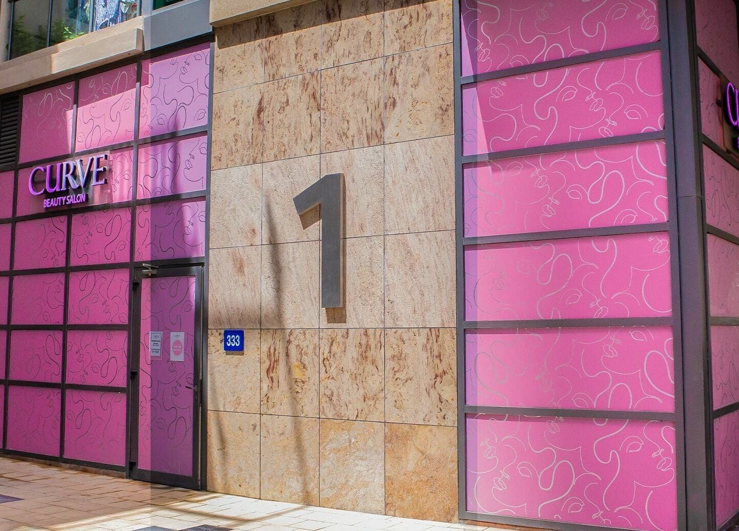 Curve Beauty Salon entrance with vibrant pink facade in Dubai, Dubai, AE.