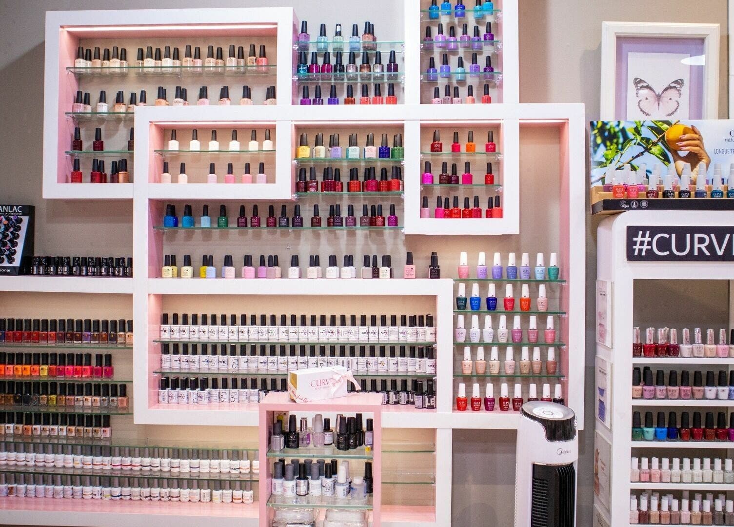 Vibrant nail polish display at Curve Beauty Salon, Dubai, Dubai, AE. A spectrum of colors showcased elegantly.