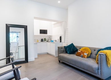 Bright, inviting interior of Waxing London Pro - Battersea, featuring a stylish sofa and modern decor in London, England, GB.