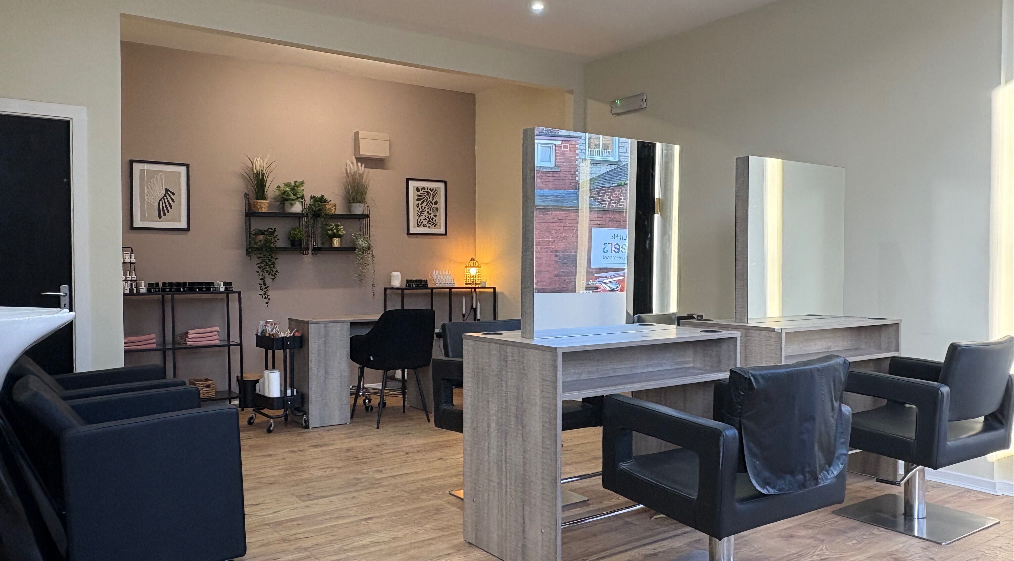 Stylish interior of Envi Hair and Beauty, Sunderland, England with sleek salon chairs and modern decor.