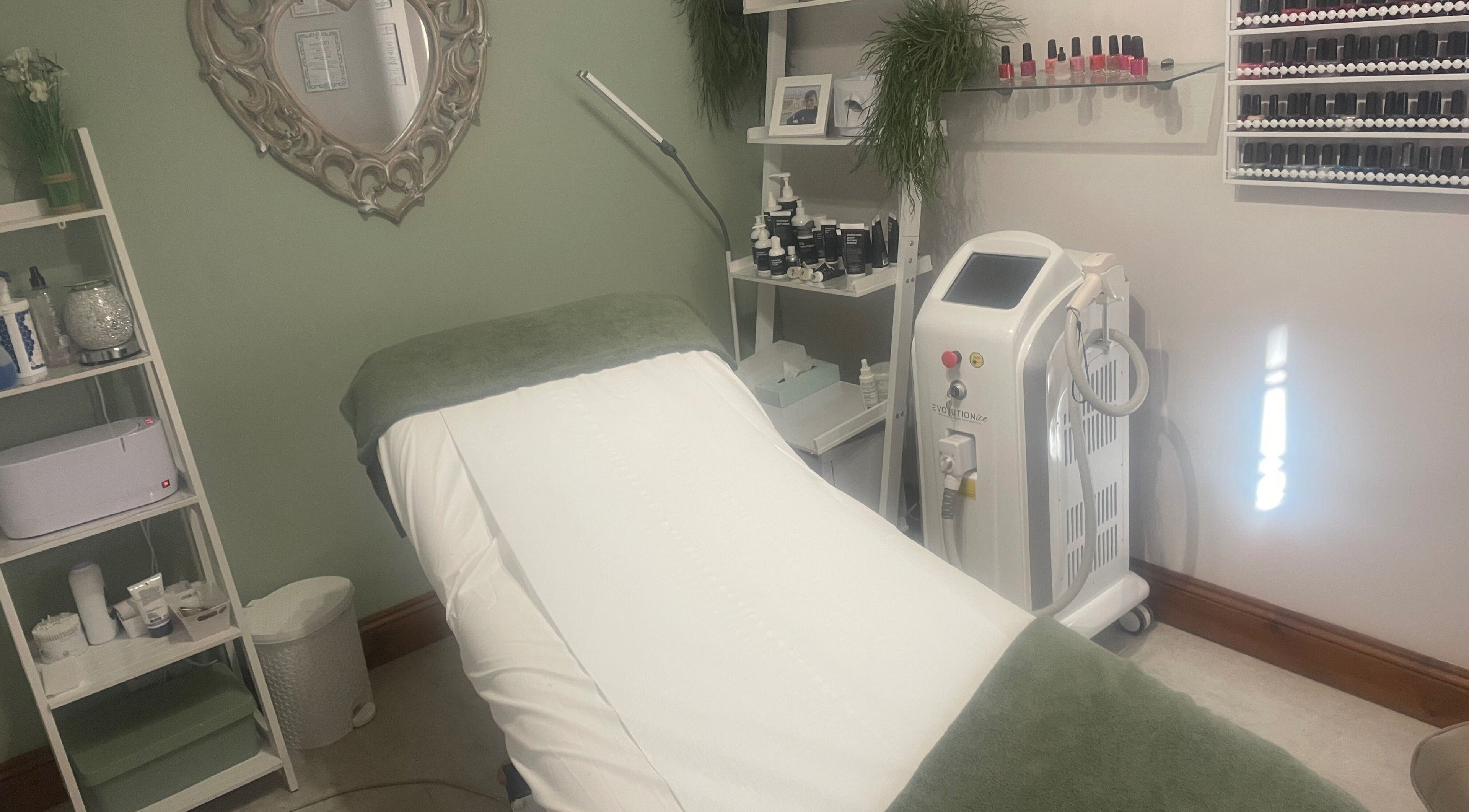 Serenity Beauty therapy room with bed and equipment in Bury St Edmunds, GB.