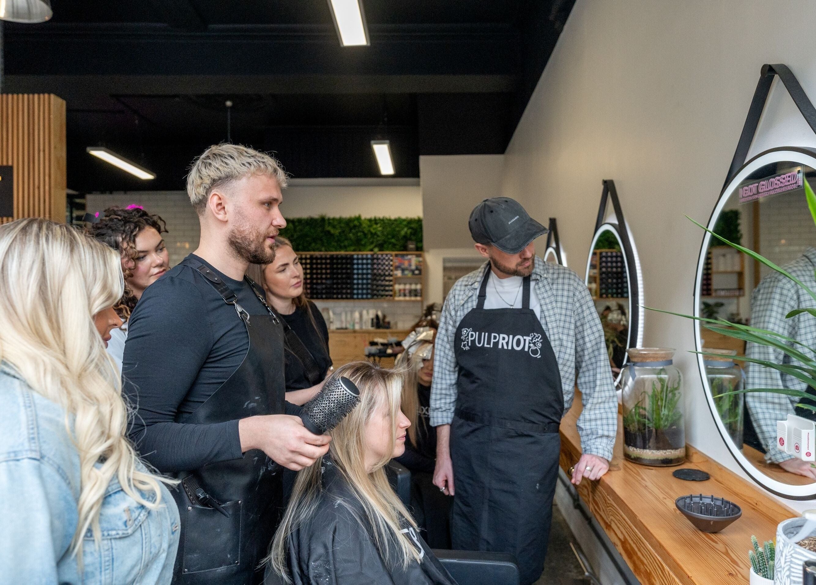 Team at Harrison Rabbitt Hair Studio in Newport, Wales, GB, collaborating on a client's hairstyle.