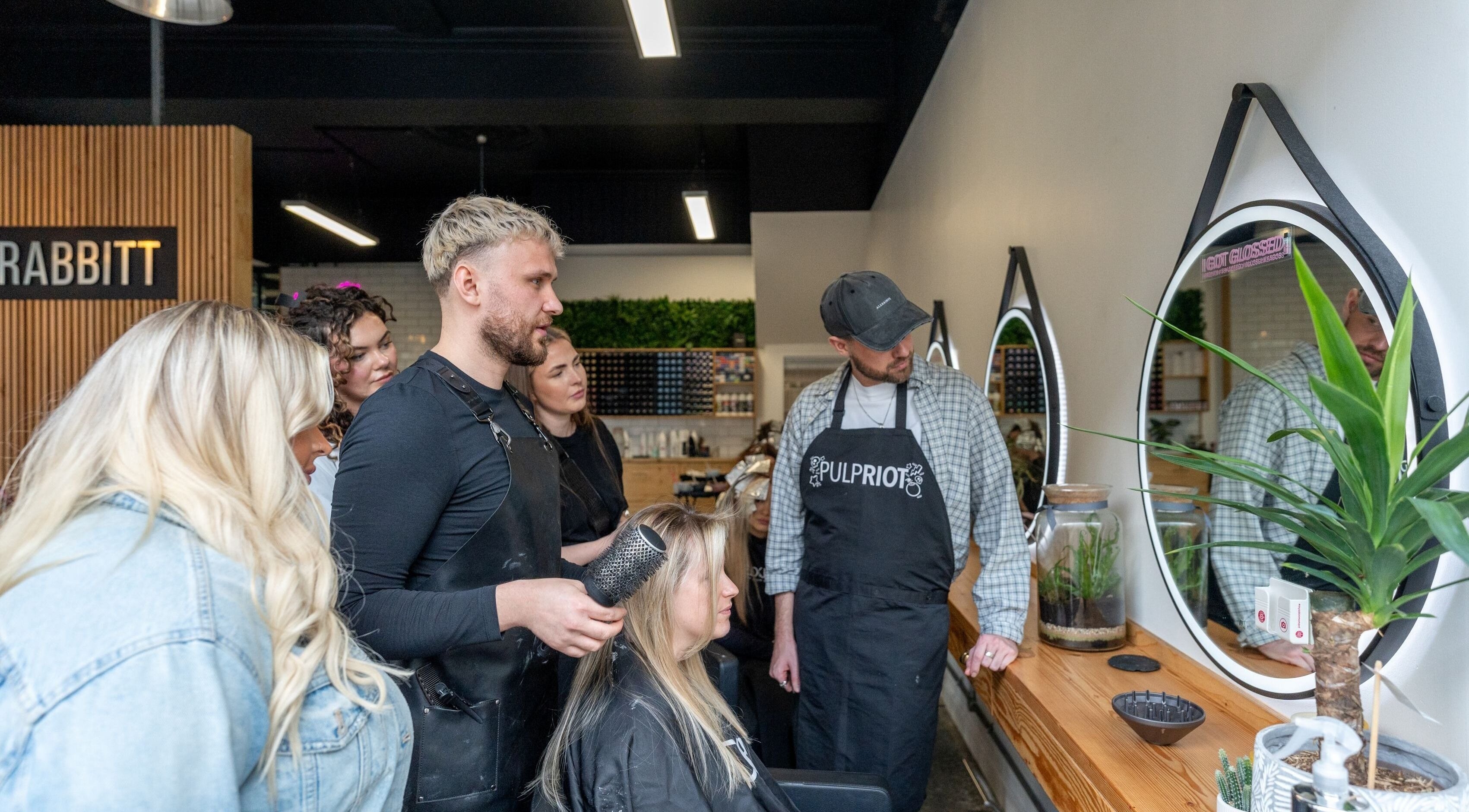 Team at Harrison Rabbitt Hair Studio in Newport, Wales, GB, collaborating on a client's hairstyle.