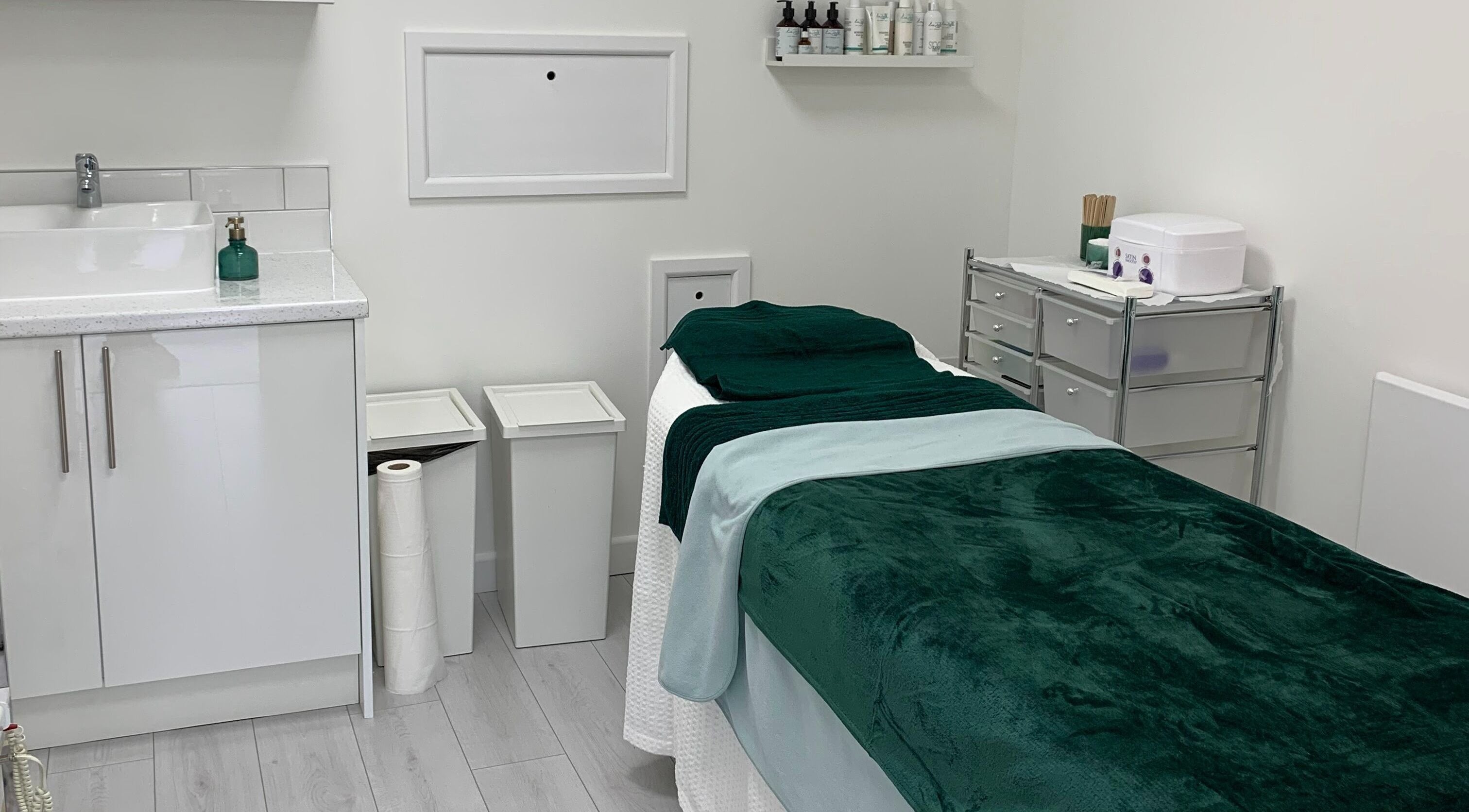 Calming treatment room at Beauty by Rebecca, Wakefield, England, GB, featuring soothing green linens.