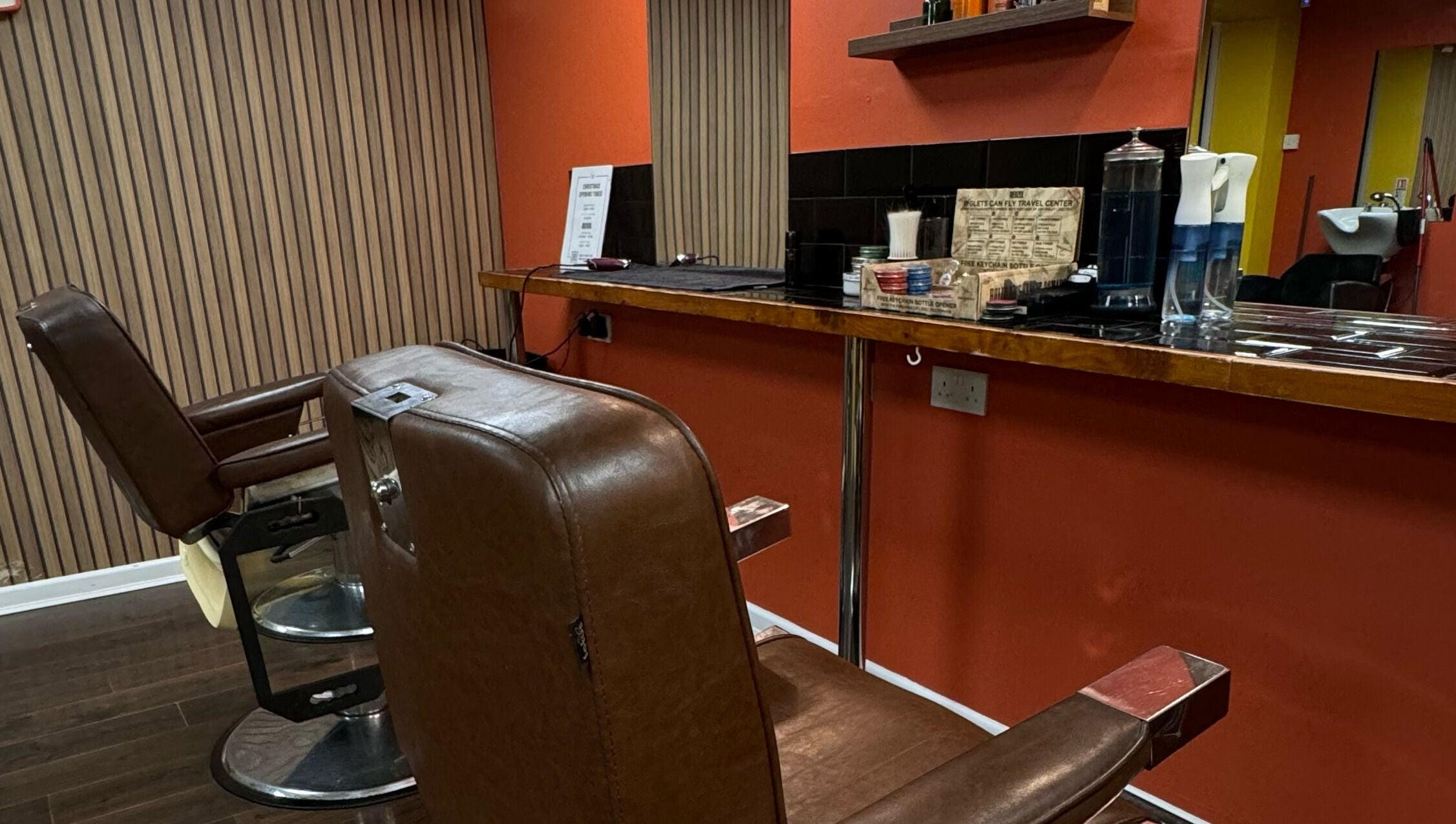 Vintage barber chair at Wild's Barbershop in Sheffield, England, GB showcasing sleek interior design.