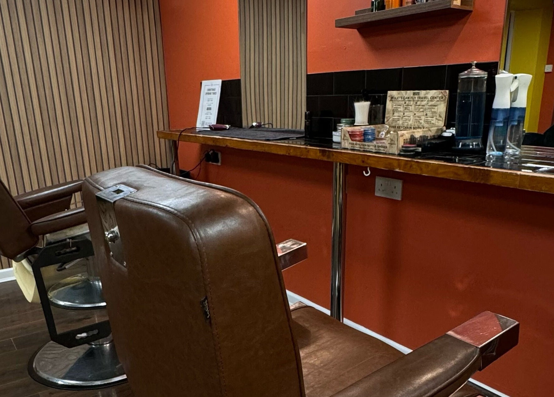Vintage barber chair at Wild's Barbershop in Sheffield, England, GB showcasing sleek interior design.
