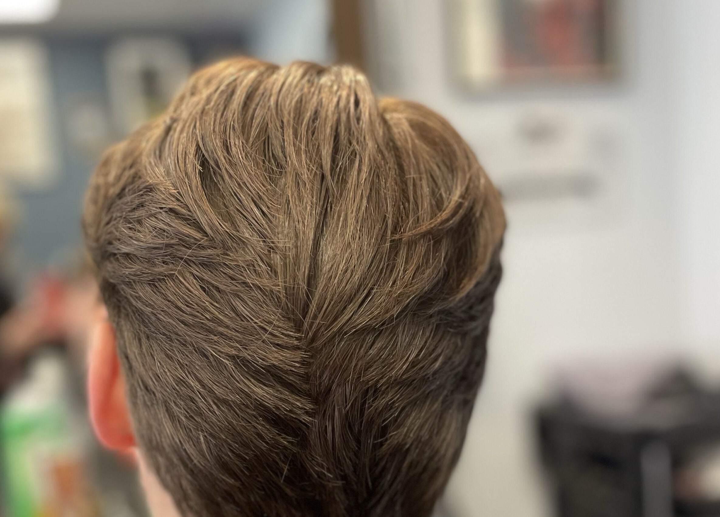 Freshly styled haircut at Wild's Barbershop, Sheffield, England, GB. Close-up of sleek, groomed hair.