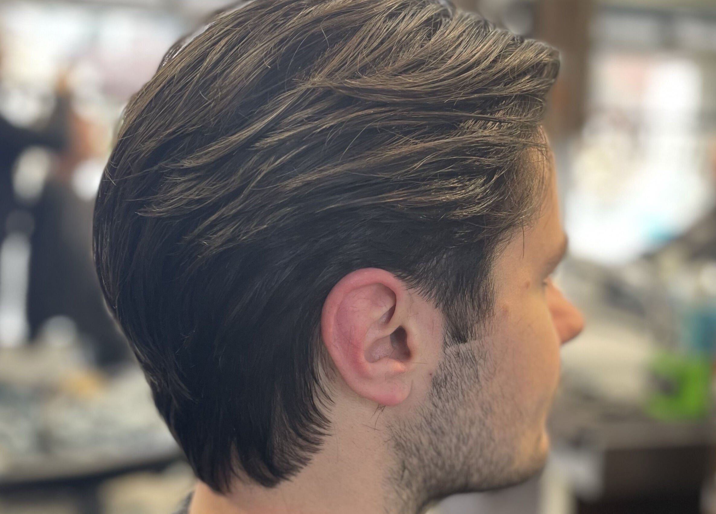 Close-up of a stylish haircut at Wild's Barbershop, Sheffield, England, GB. Modern grooming in a cozy setting.
