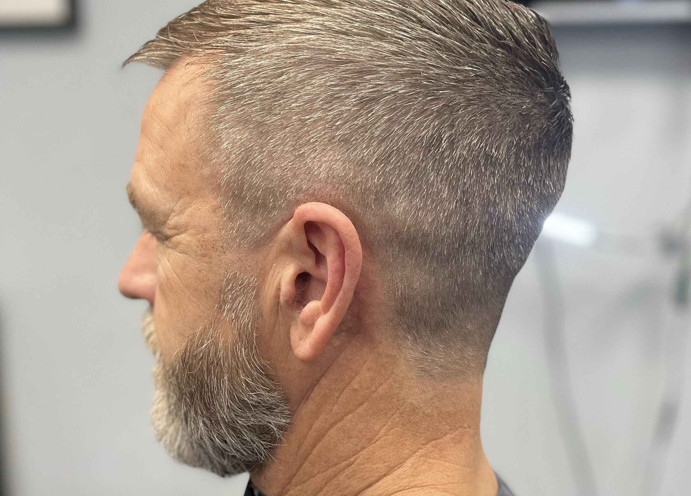 Close-up of a stylish fade haircut at Wild's Barbershop, Sheffield, England, GB, showcasing precise barber skills.