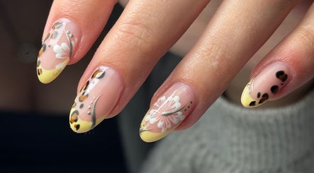 Elegant floral nail art by Georgina.NailArtist at Keighey, England, GB. Yellow and black accents enrich the design.