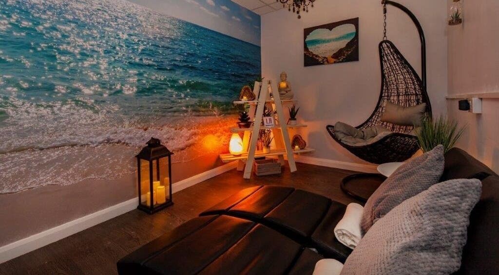 Relaxing coastal-themed room at LA Beauty and Spa in Aston, England, GB with cozy chairs and beach mural.
