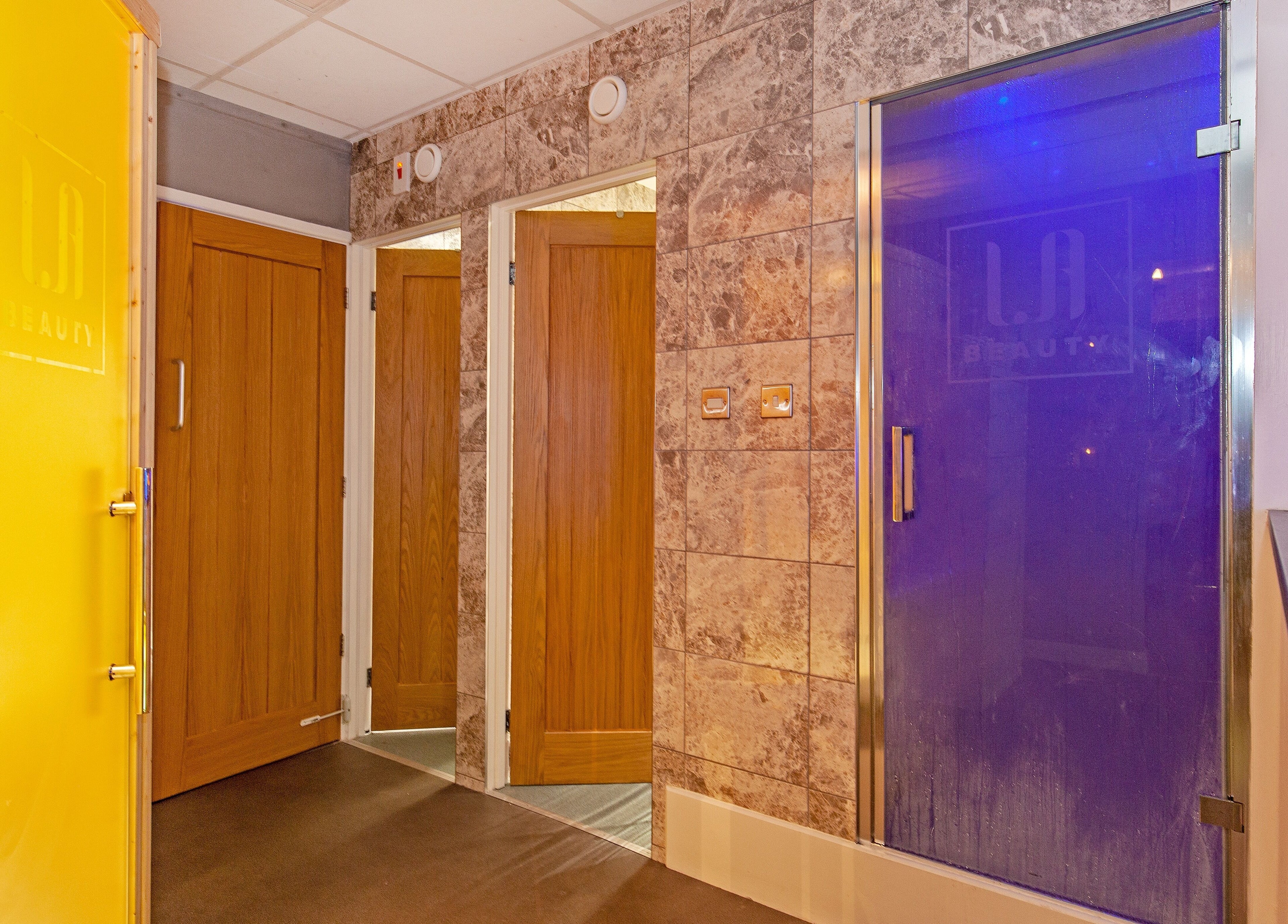 Elegant spa entry doors at LA Beauty and Spa in Aston, England, GB, offering a tranquil welcoming atmosphere.