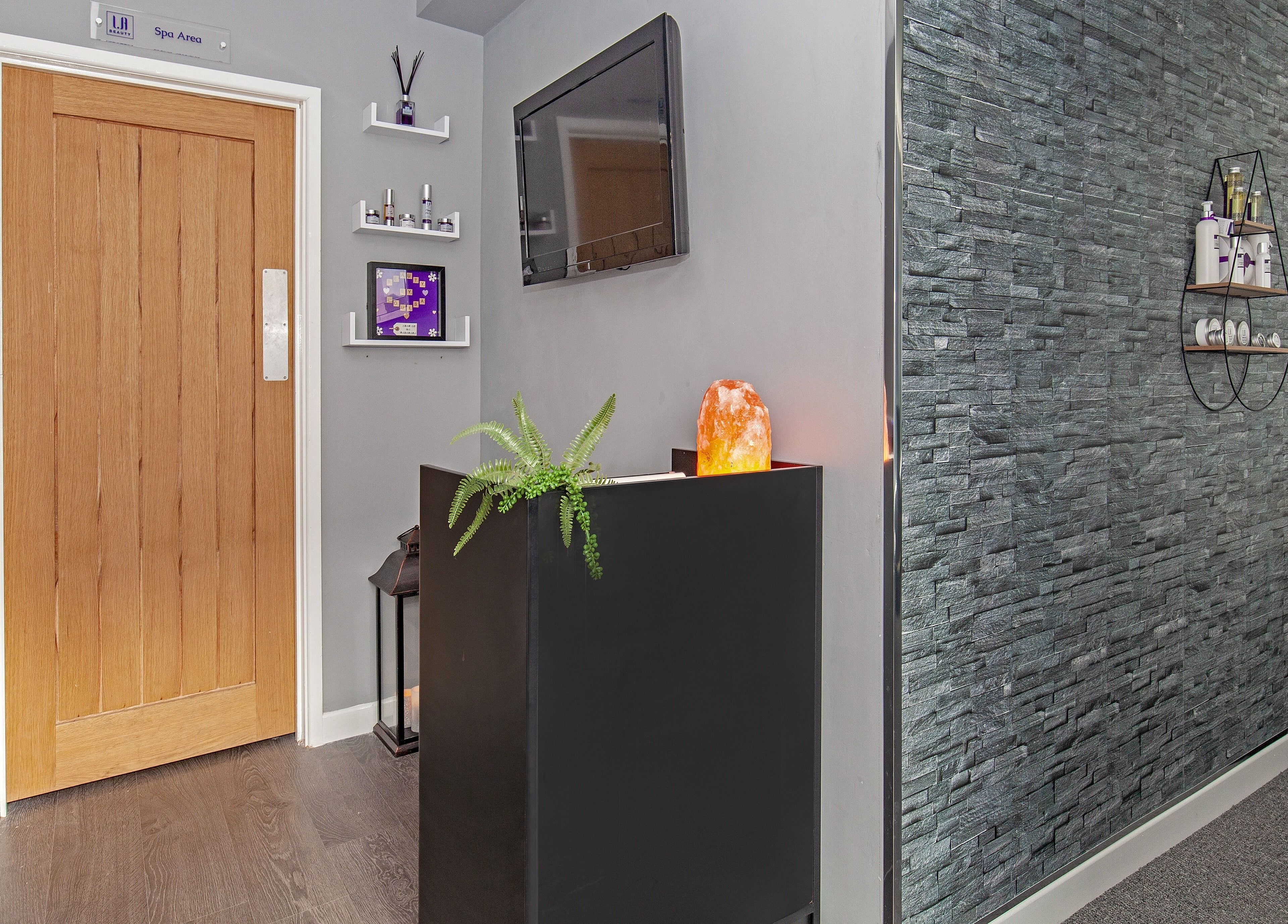 Reception area at LA Beauty and Spa, Aston, England, GB, featuring modern decor and a Himalayan salt lamp.