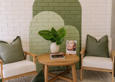 Cozy seating area at Salt Beauty Ballina, Ballina, New South Wales, AU with green pillows and plant decor.