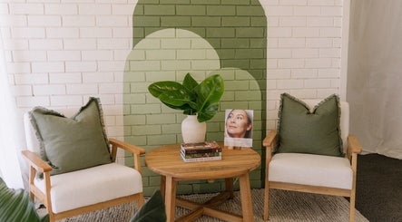 Cozy seating area at Salt Beauty Ballina, Ballina, New South Wales, AU, with green accents and books.