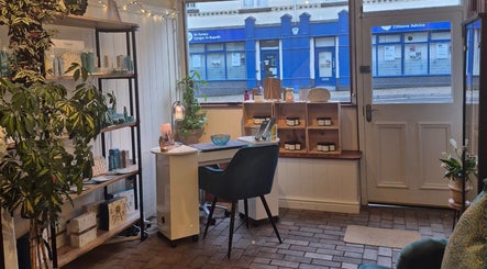Cozy Room 2 in Abergavenny, Wales, GB filled with plants and beauty products for relaxation and wellness.