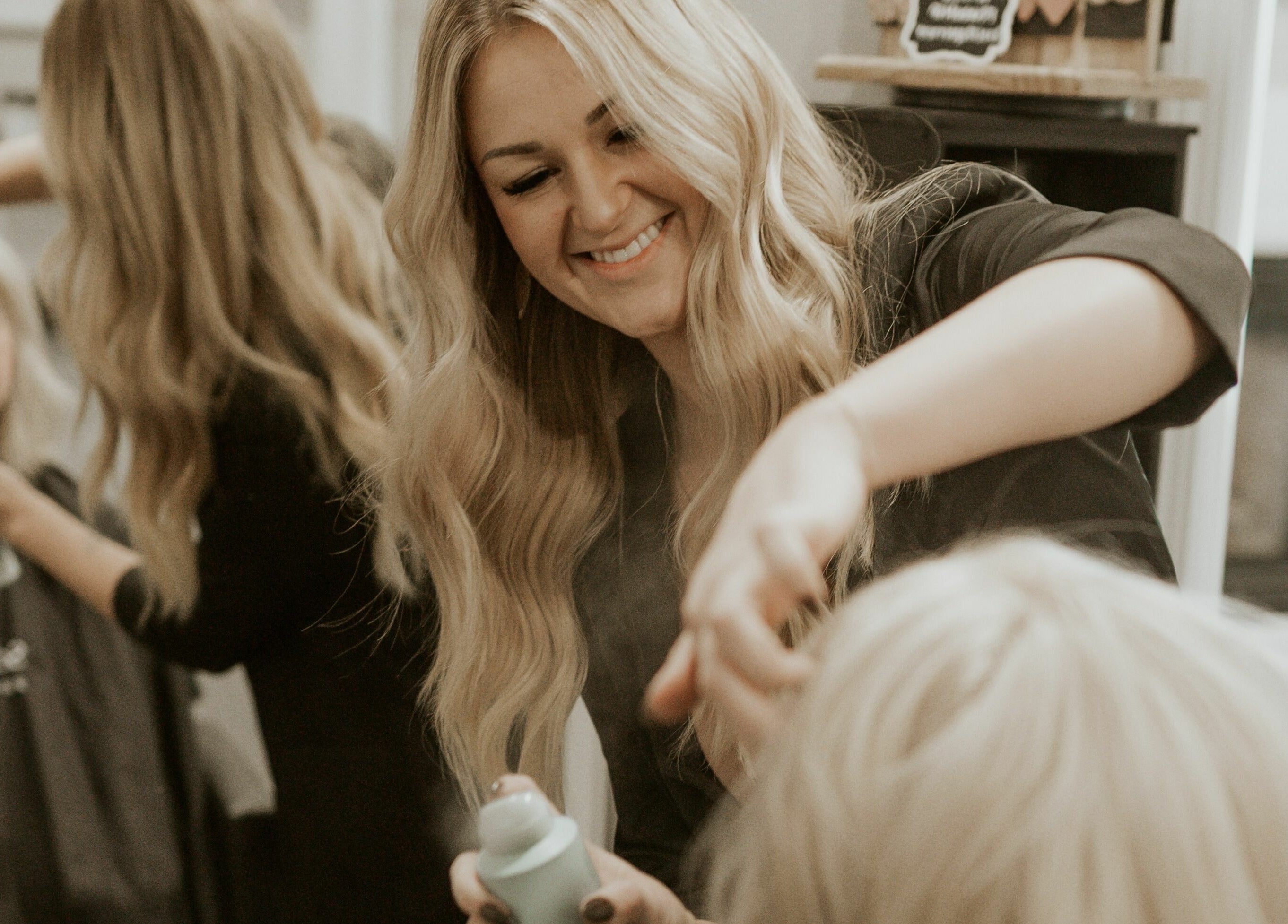Stylist attends to client at Remedy Salon, Appleton, Wisconsin, US creating a perfect hair look.