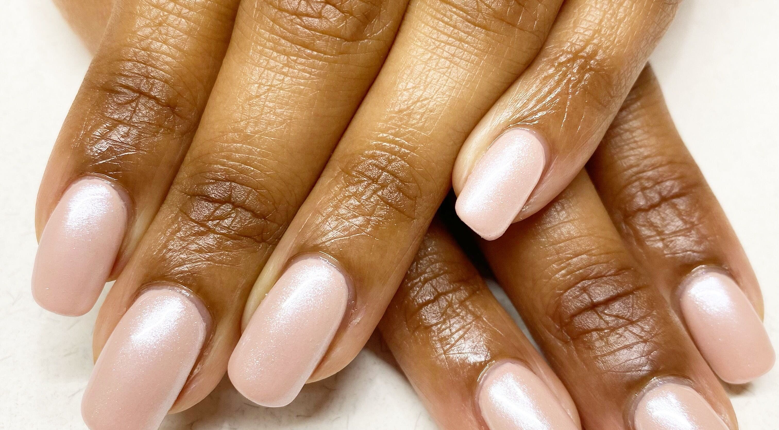 Elegant pearlescent manicure by Nails by Kirstie in Wellington, Wellington, NZ showcases glossy, soft pink nails.
