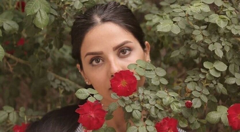 Woman with roses at Shivilashes, Coquitlam, British Columbia, CA. Captivating beauty among vibrant blooms.