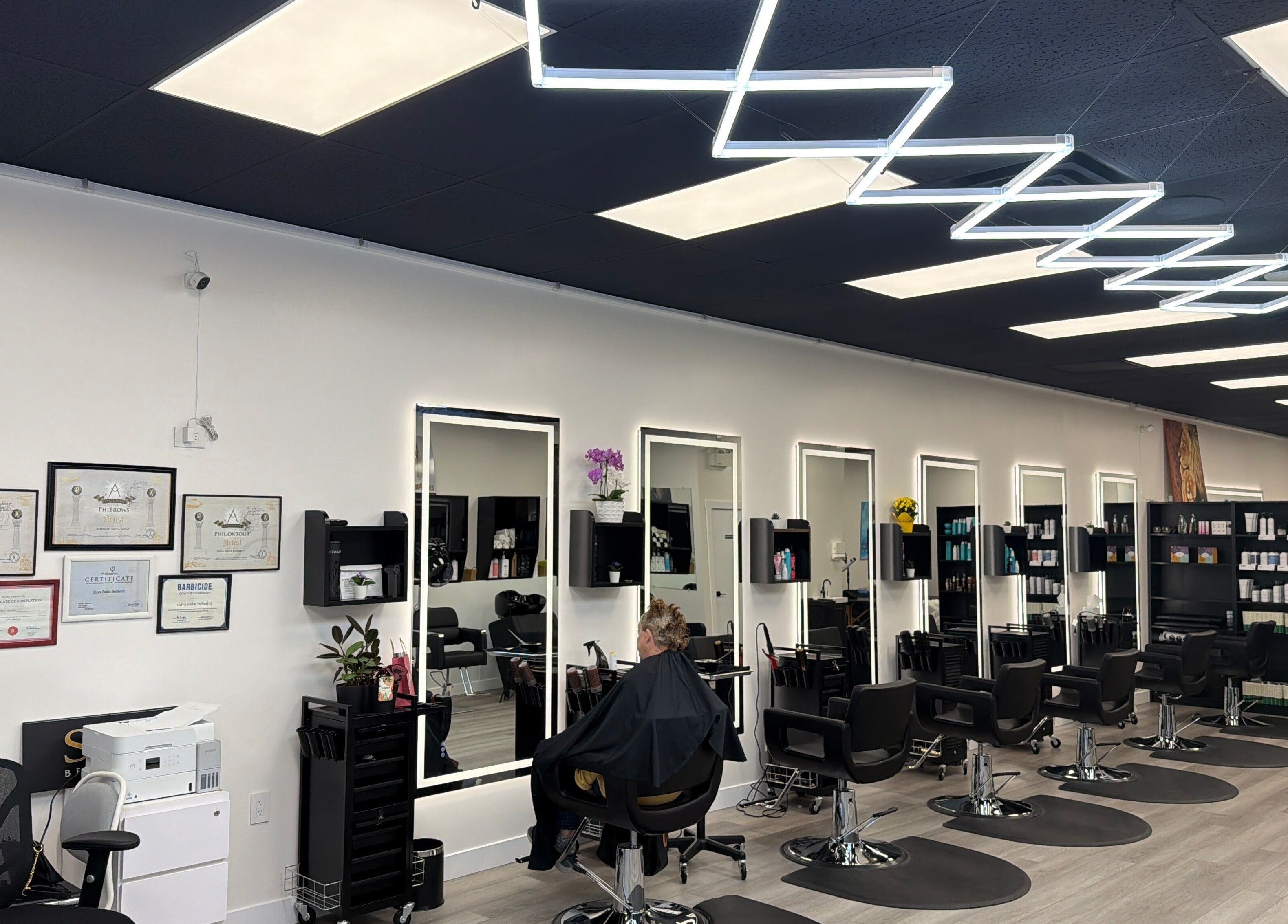 Inside Shivilashes salon in Coquitlam, BC, showcasing chic styling chairs and sleek, mirrored stations.