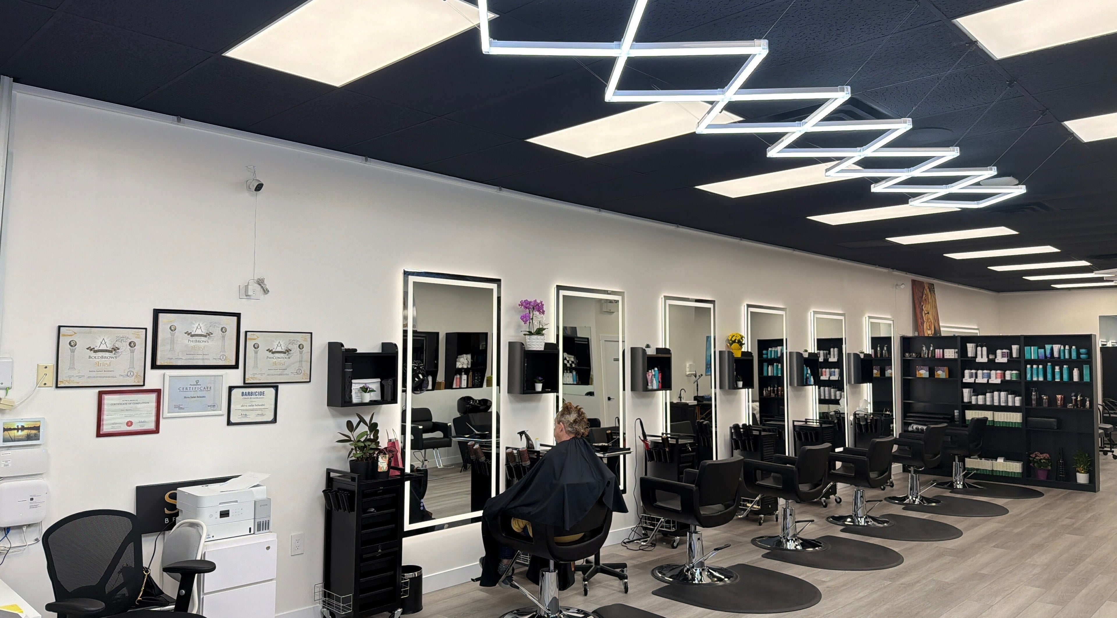Inside Shivilashes salon in Coquitlam, BC, showcasing chic styling chairs and sleek, mirrored stations.