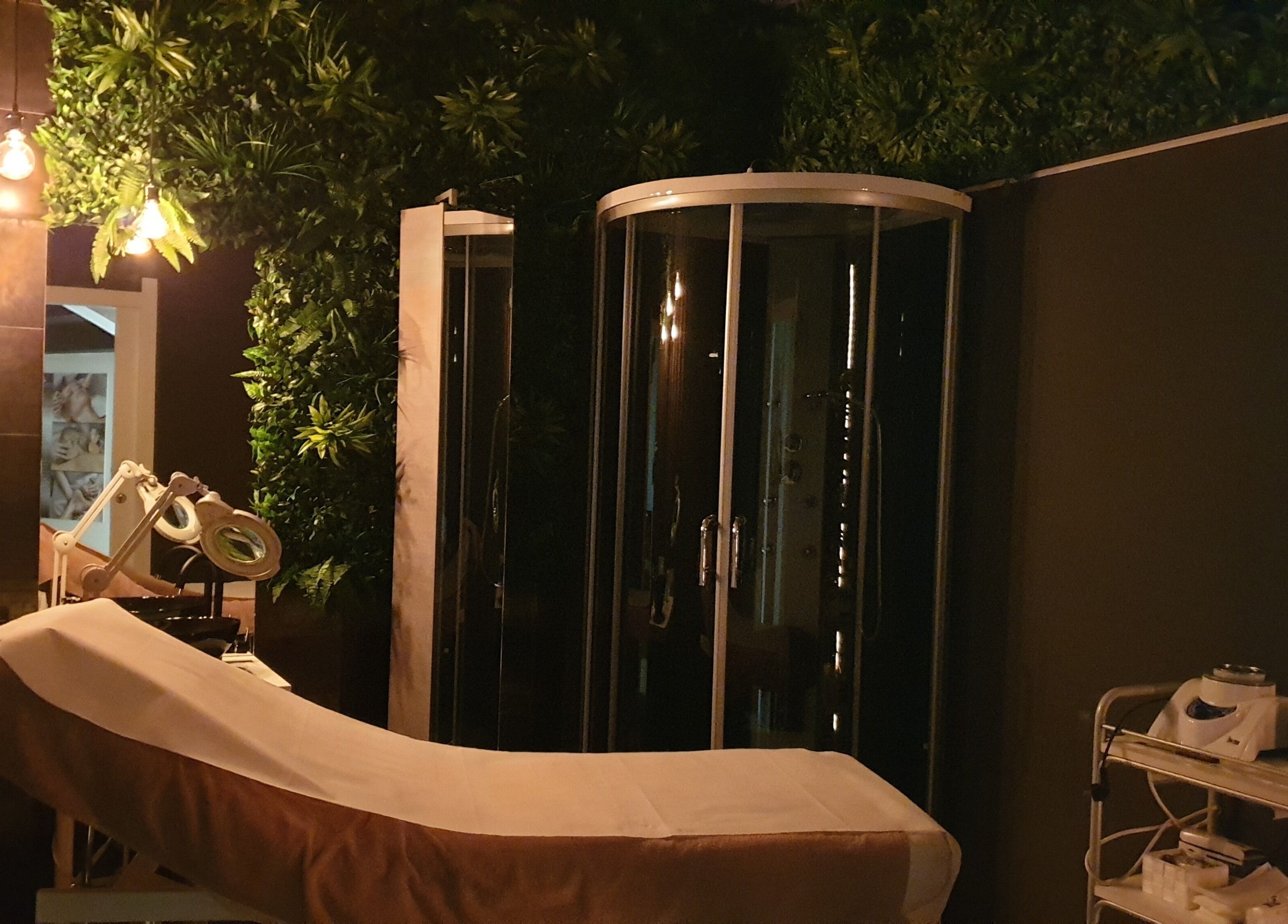 Elegante cabina spa a Farfalla Beauty and Wellness, Sassari, Sardegna, IT, con atmosfera rilassante e arredamento verde.