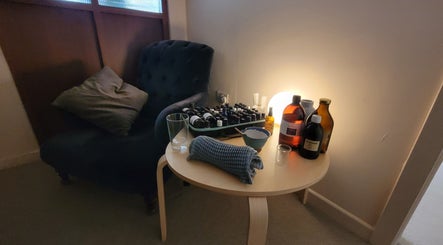 Relaxing corner at AmberLuna Apothecary in Bristol, England. Cozy chair and essential oils create a tranquil ambiance.