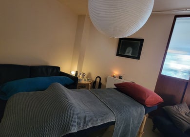 Relaxing treatment room at AmberLuna Apothecary in Bristol, England, GB featuring a comfortable massage table.