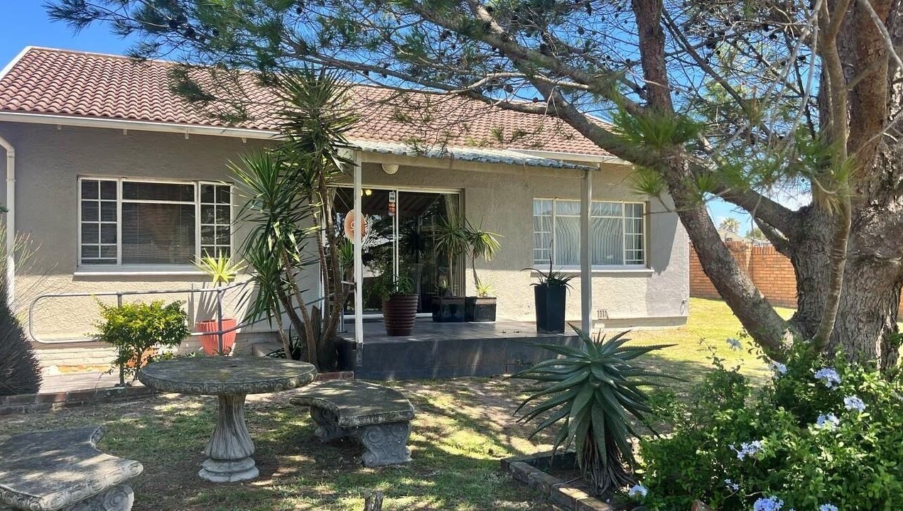 Charming exterior of Perfectly Splendid in Gqeberha, Eastern Cape, ZA, with lush garden seating.