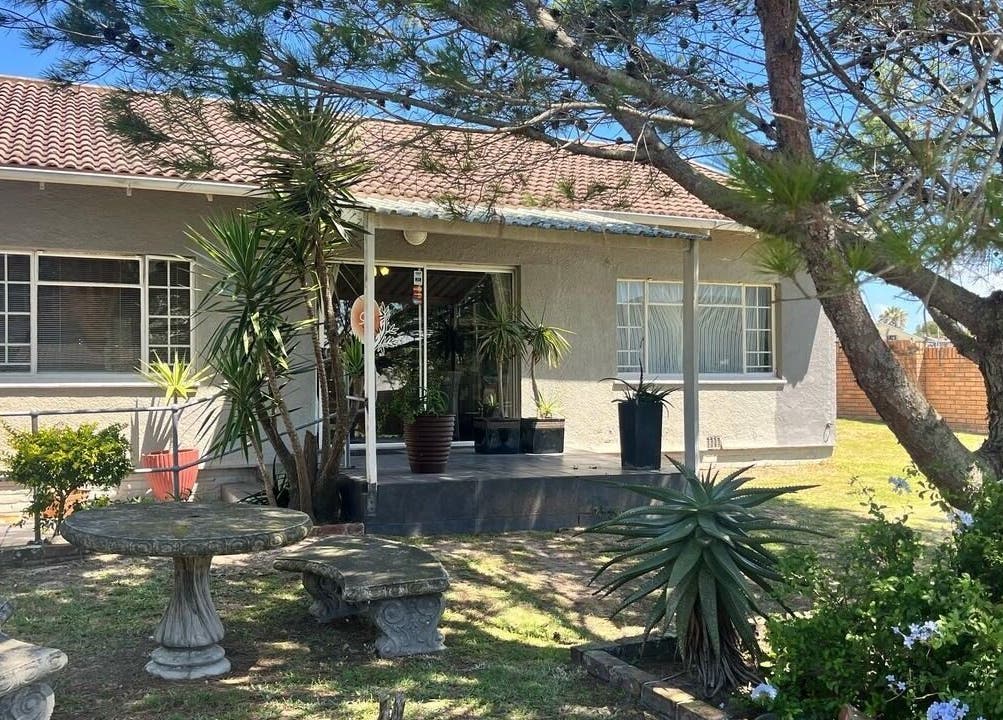 Charming exterior of Perfectly Splendid in Gqeberha, Eastern Cape, ZA, with lush garden seating.