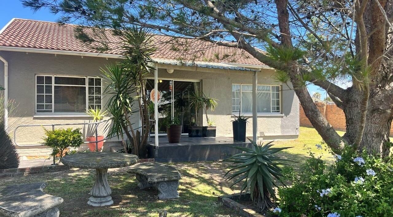 Charming exterior of Perfectly Splendid in Gqeberha, Eastern Cape, ZA, with lush garden seating.