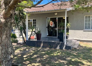 Charming entrance to Perfectly Splendid in Gqeberha, Eastern Cape, ZA, surrounded by lush greenery.