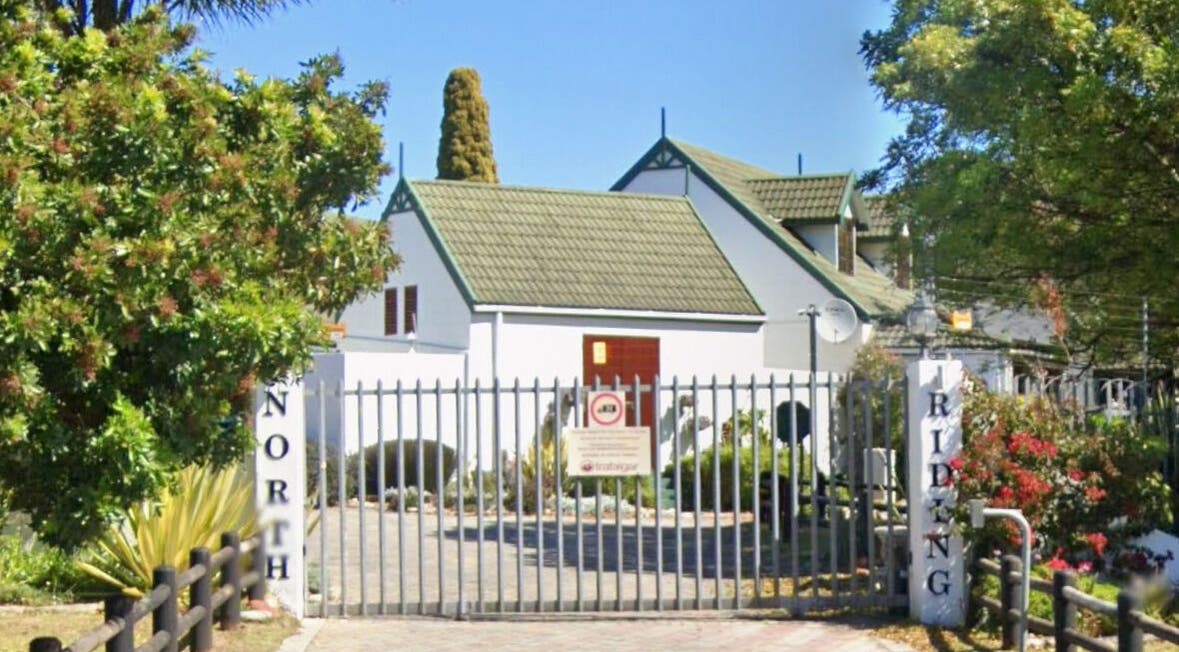 Entrance of Perfectly Splendid By Lucinda Hill, a serene venue in Gqeberha, Eastern Cape, ZA surrounded by lush greenery.