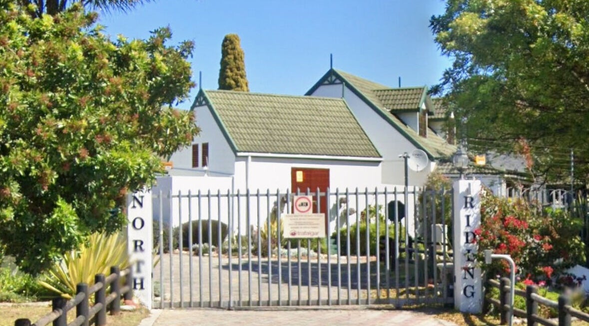 Entrance of Perfectly Splendid By Lucinda Hill, a serene venue in Gqeberha, Eastern Cape, ZA surrounded by lush greenery.