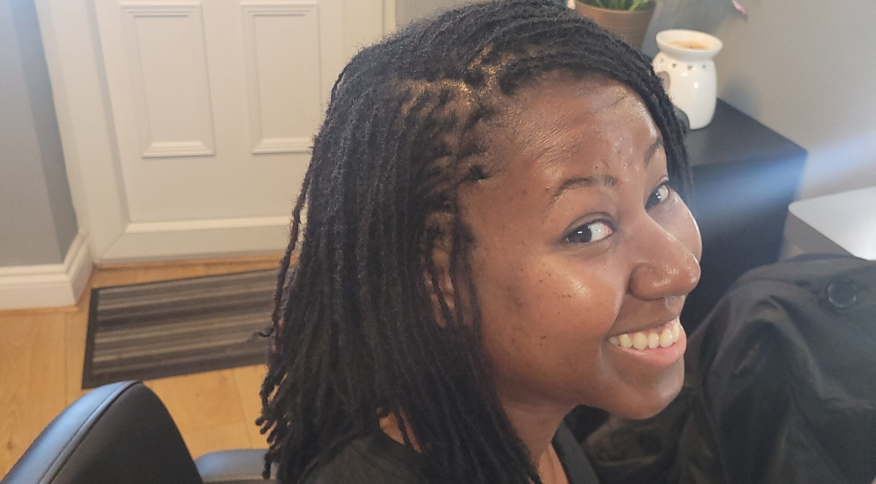 Smiling customer at Natural Touch Hair Studio, Enfield, Middlesex, GB, flaunting styled dreadlocks.