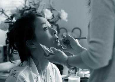 Makeup artist applying lipstick at Abundance of Beauty, Birmingham, England, GB. Elegance in beauty services.
