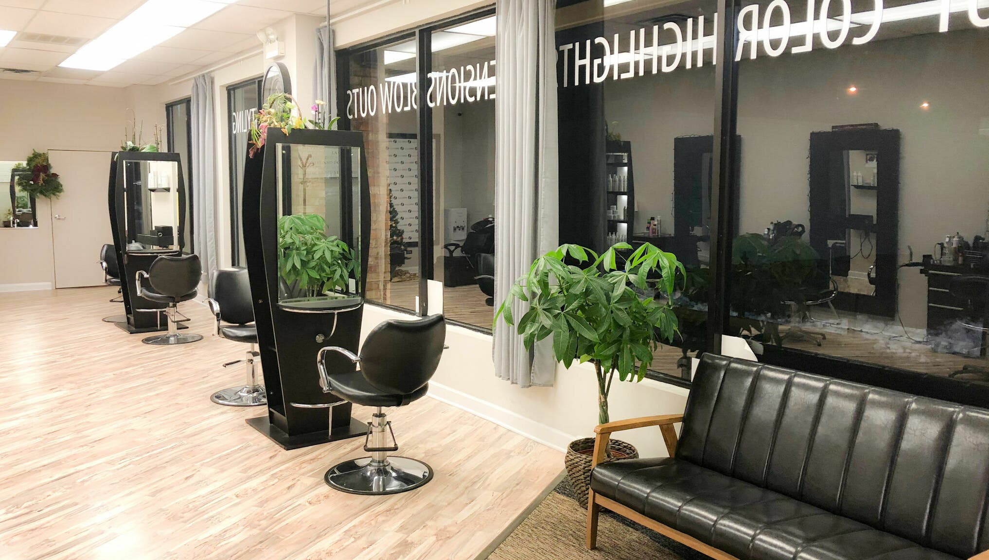 Stylish interior of Surge Salon in Glen Ellyn, Illinois, US, with modern stations and lush plants.