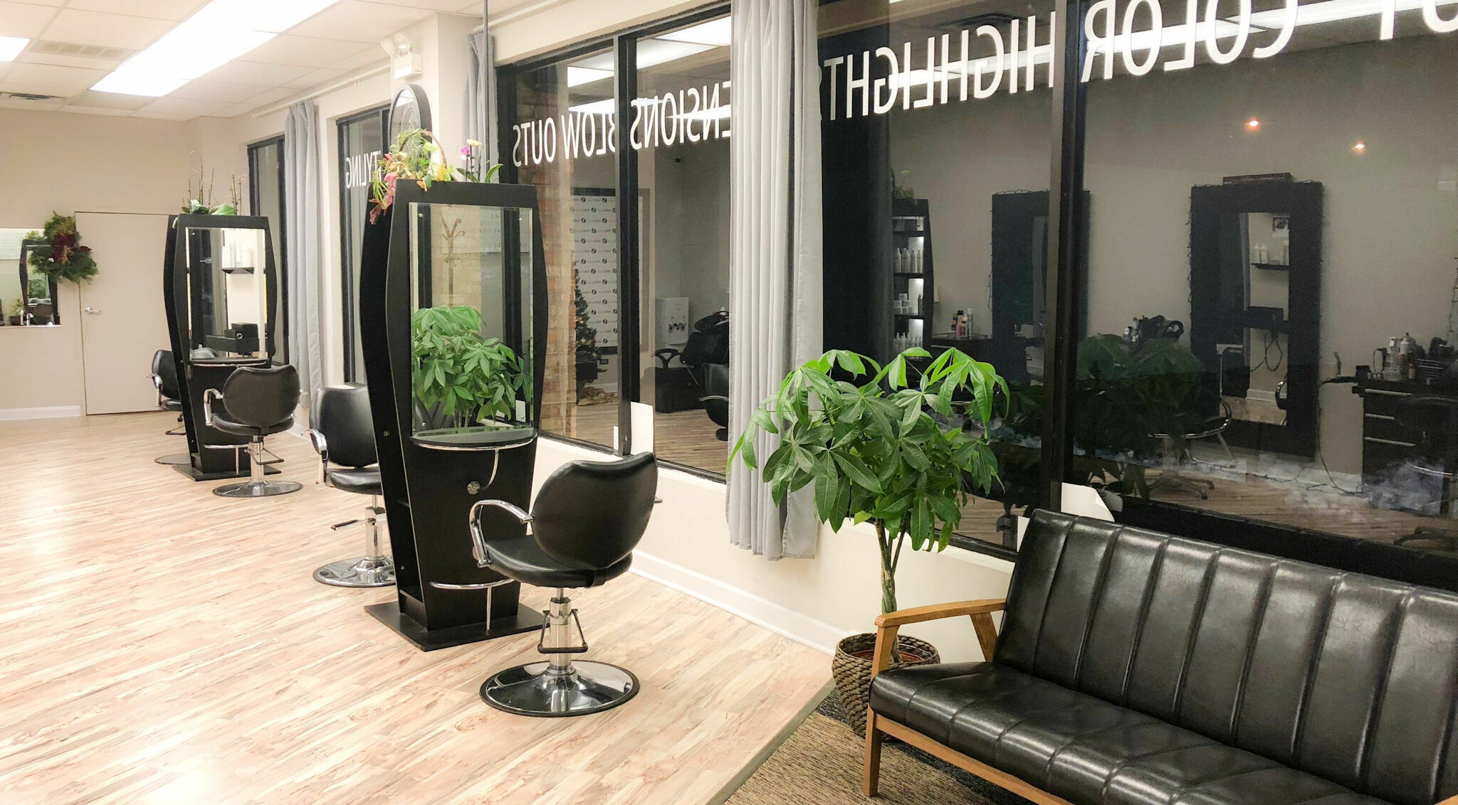 Stylish interior of Surge Salon in Glen Ellyn, Illinois, US, with modern stations and lush plants.