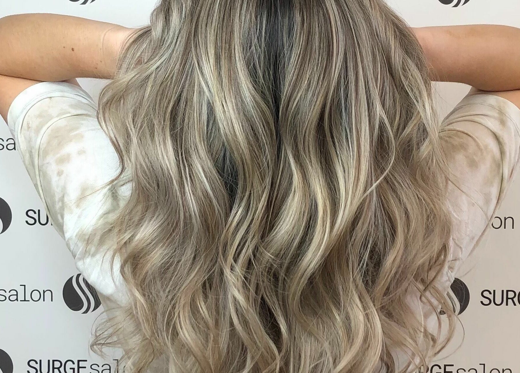 Gorgeous wavy blonde hair styled at Surge Salon in Glen Ellyn, Illinois, US, highlighting luxurious color and texture.