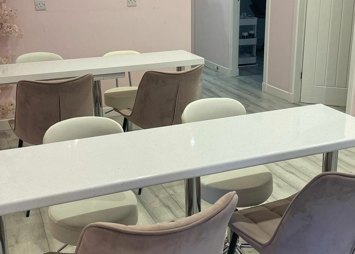 Chic seating area at Nickies Salon & Academy, Musselburgh, Scotland, GB with stylish chairs and modern tables.