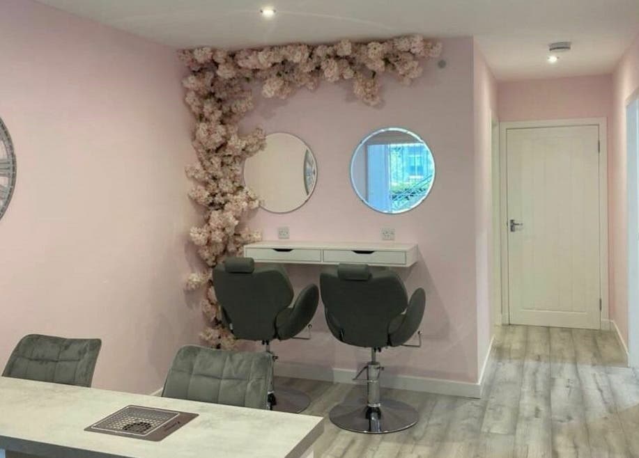 Chic beauty nook at Nickies Salon & Academy in Musselburgh, Scotland, GB with soft pink walls and stylish seating.