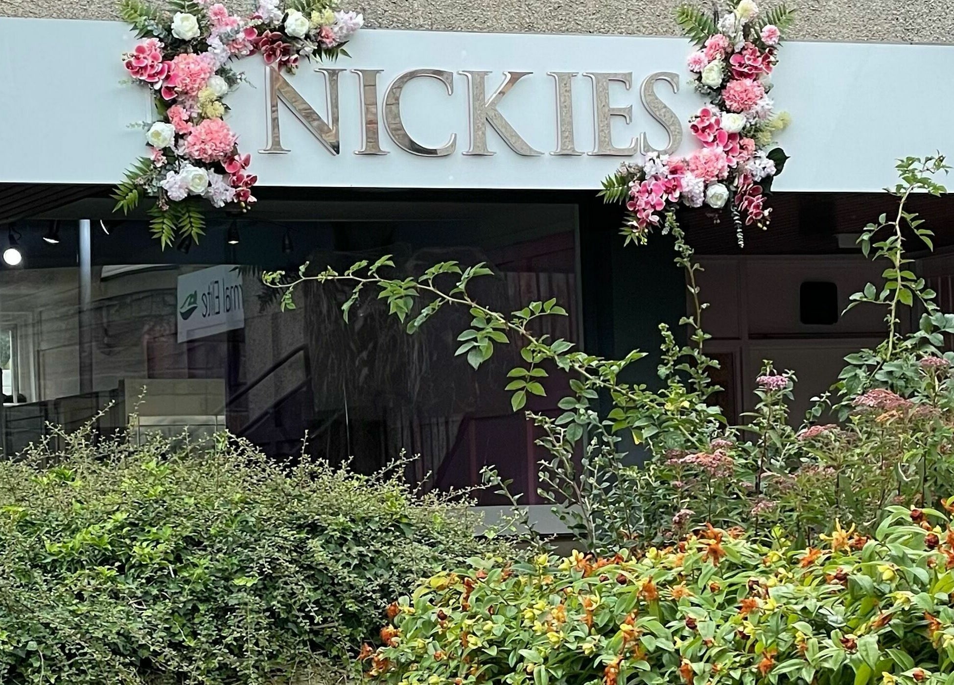 Entrance of Nickies Salon & Academy, adorned with flowers in Musselburgh, Scotland, GB.