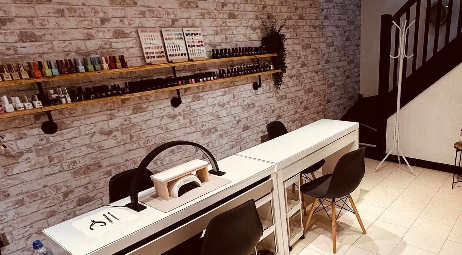 Modern nail station at The Hair Lounge in Penzance, England, GB. Sleek setup with nail polishes and accessories.