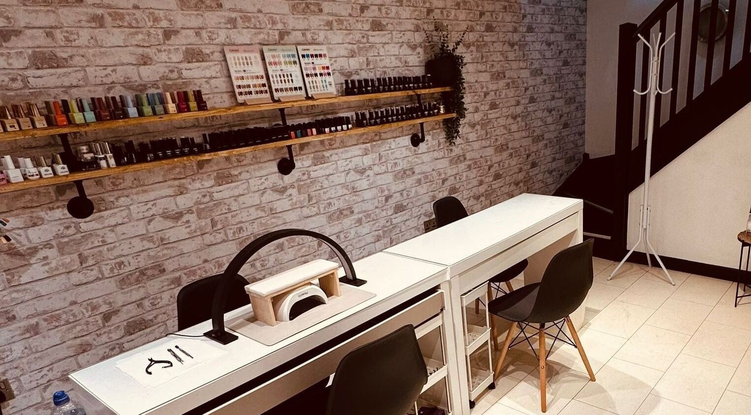 Modern nail station at The Hair Lounge in Penzance, England, GB. Sleek setup with nail polishes and accessories.