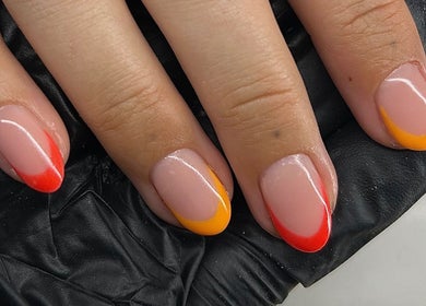 Vibrant red and orange nail art at Beautology Newcastle, Whitley Bay, England, GB.