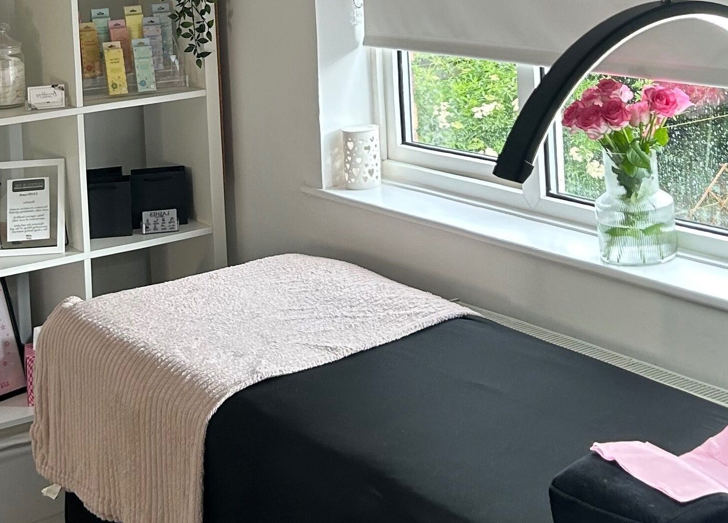 Treatment room at Beautology Newcastle, Whitley Bay, England, GB with pink roses and elegant decor.
