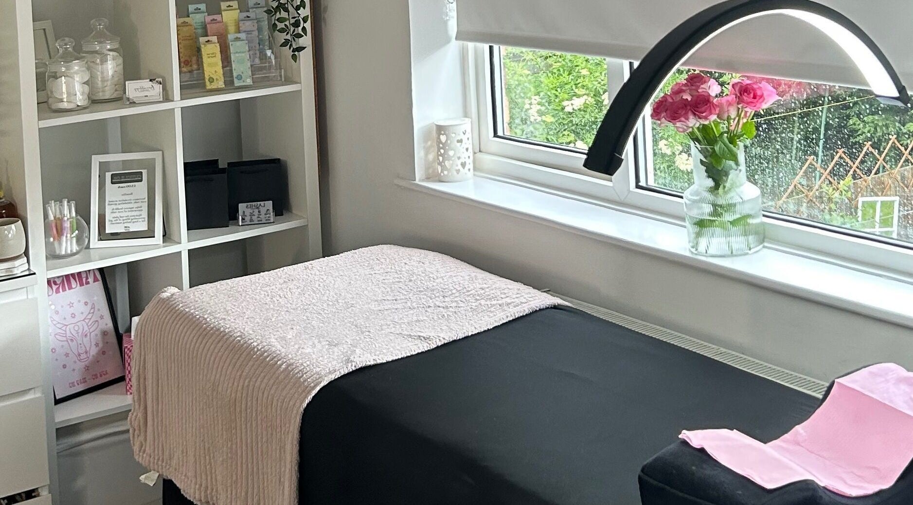 Treatment room at Beautology Newcastle, Whitley Bay, England, GB with pink roses and elegant decor.