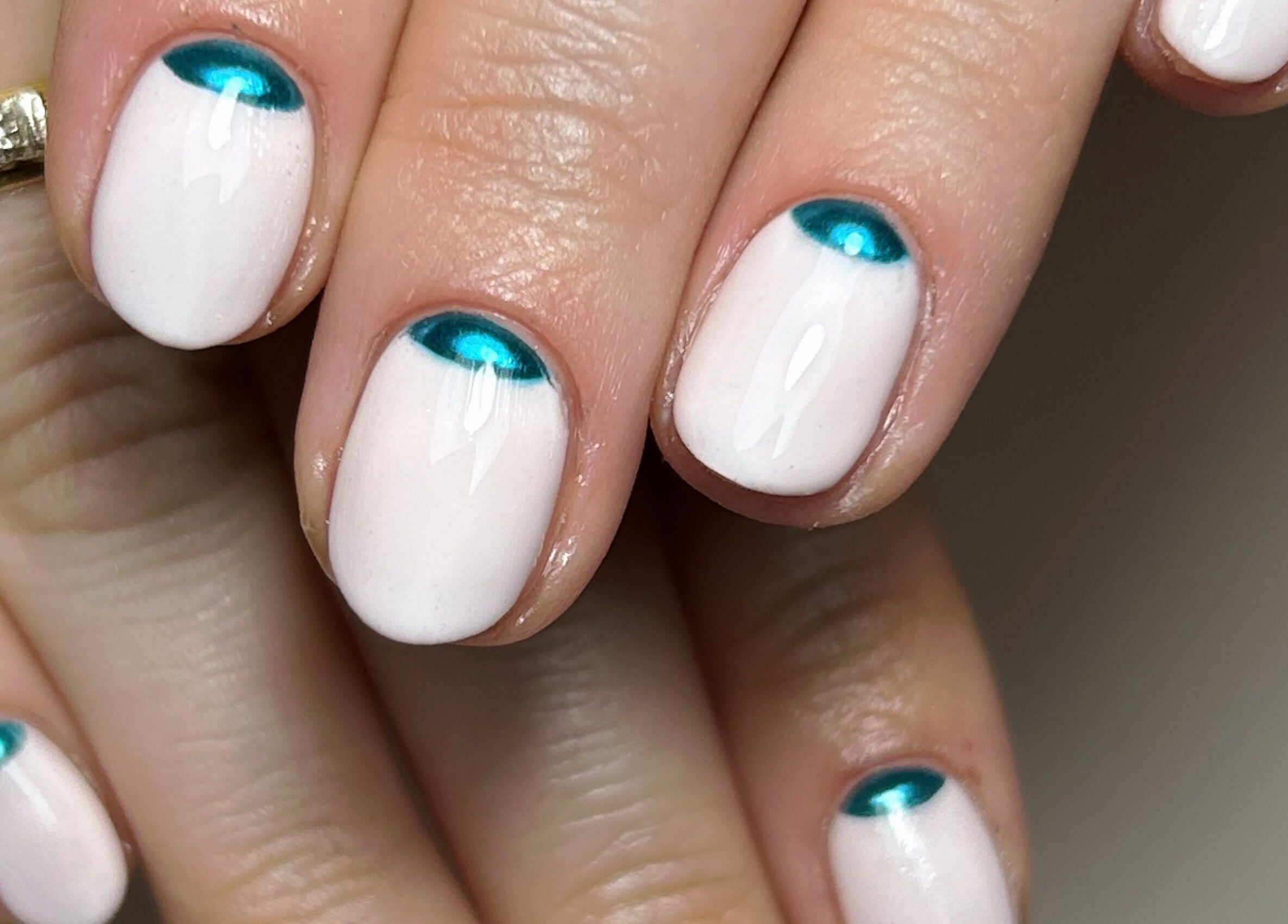 Elegant white nails with teal accents at Beautology Newcastle, Whitley Bay, England, GB.